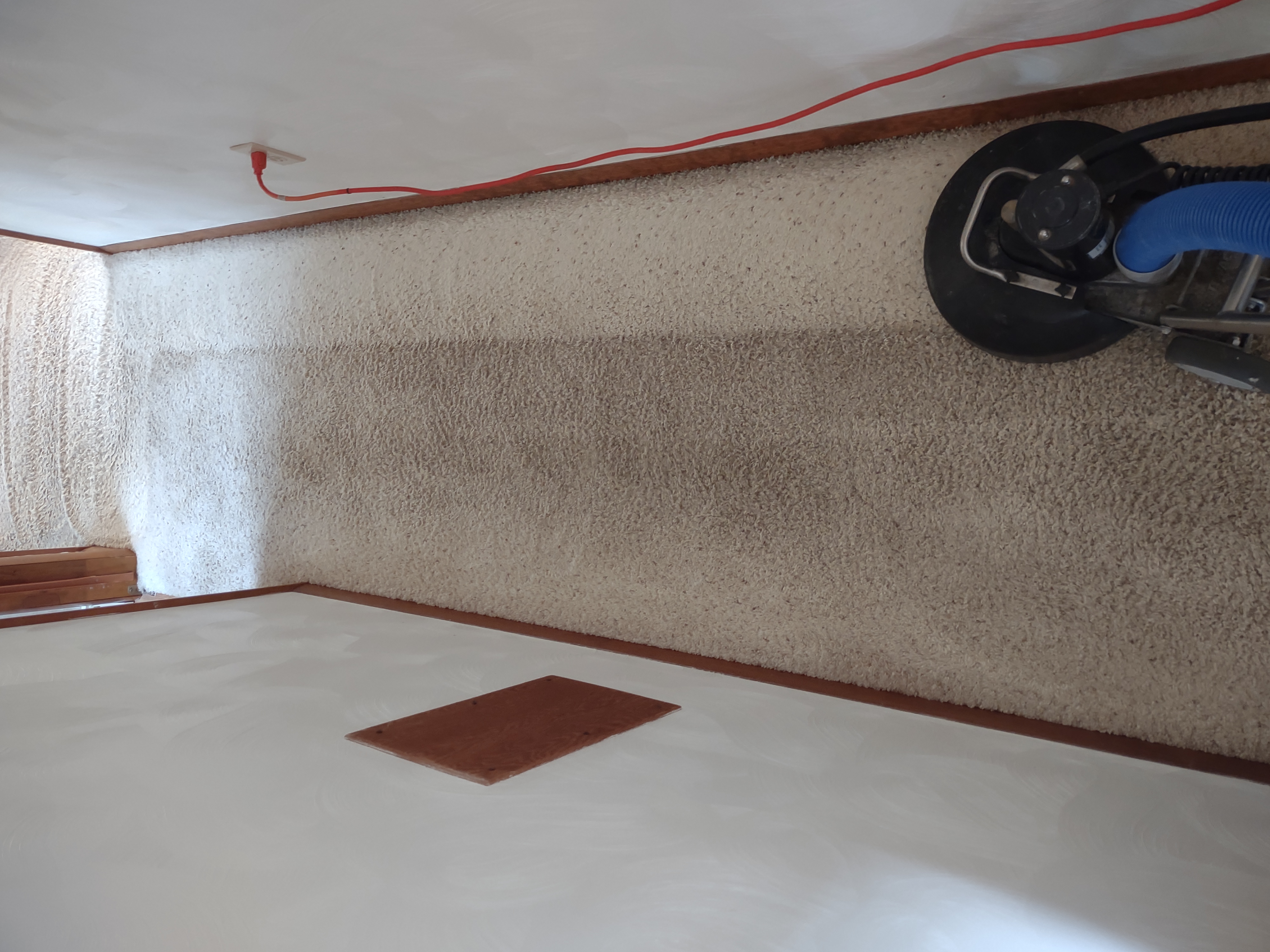 Professional carpet cleaning in progress on residential stairway with equipment