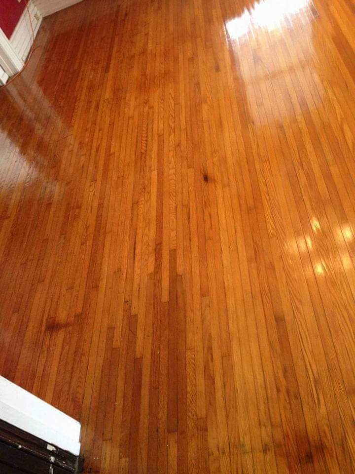 Polished hardwood flooring with warm medium-brown tone and natural wood grain patterns