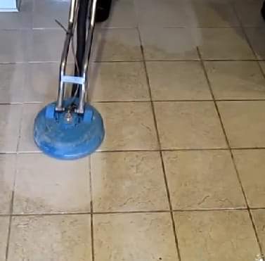 Professional tile floor being cleaned with rotary buffer machine